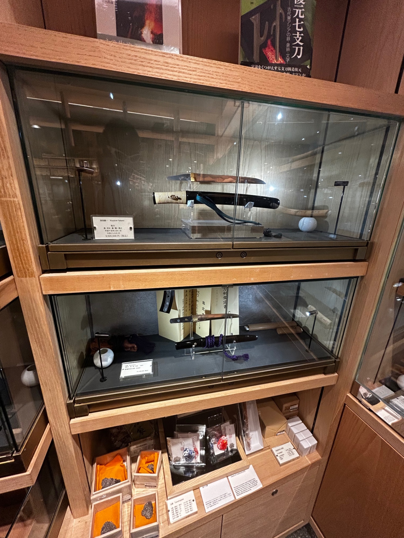 Antique Japanese katana on display in a wooden case