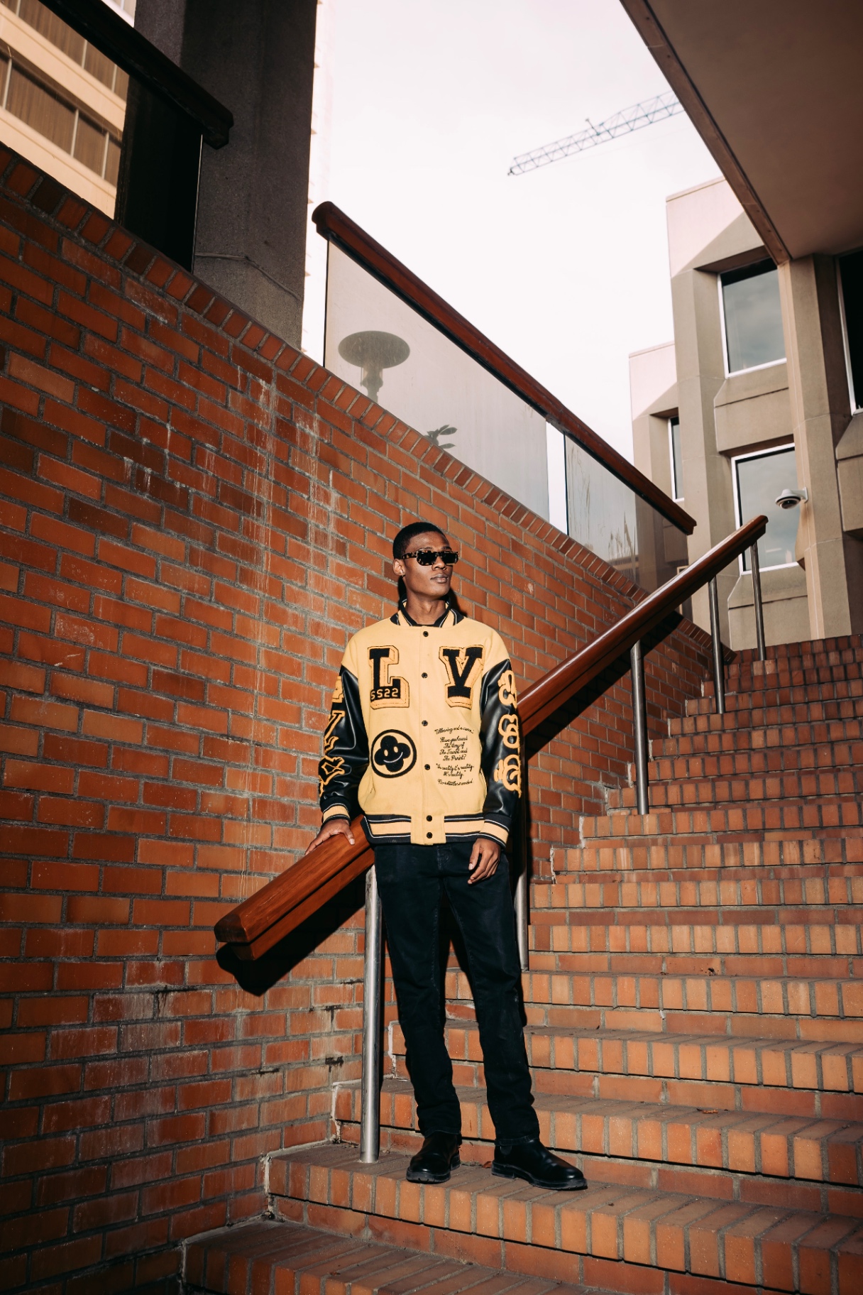 Varsity jacket, brick stairwell