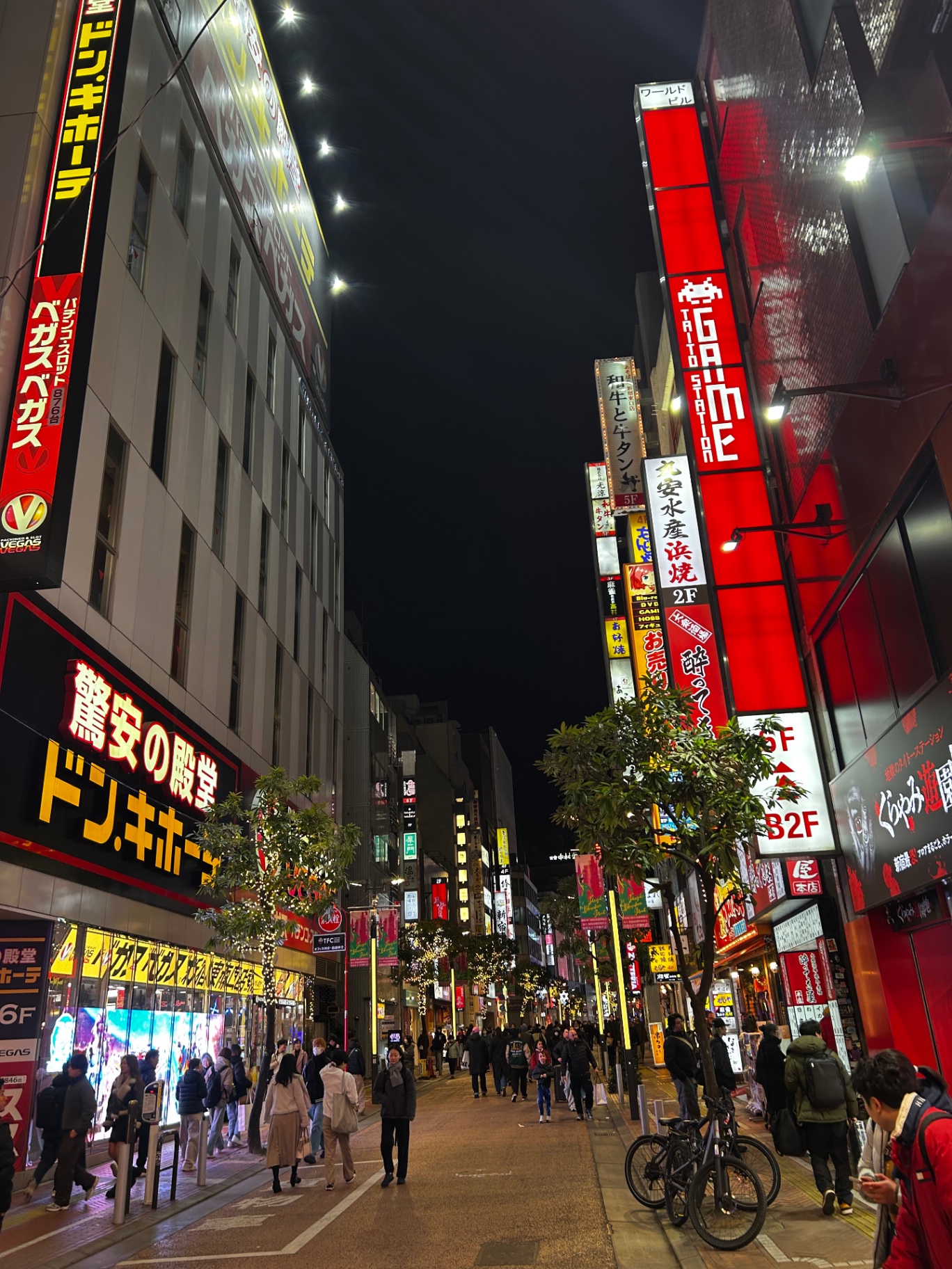 Shinjuku street glowing with neon signs
