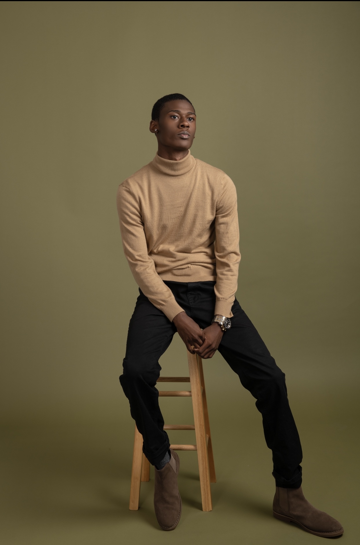 Camel turtleneck on stool