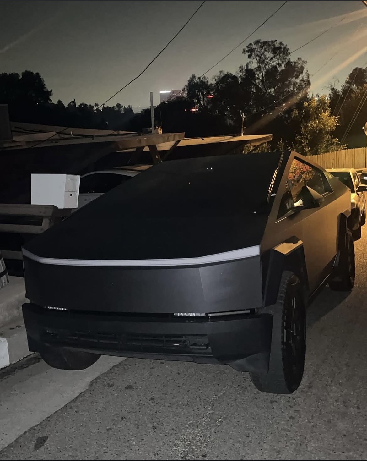 Matte black Tesla Cybertruck at dusk