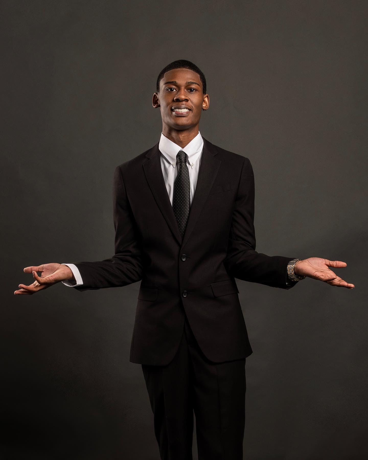 Black suit, open arms studio