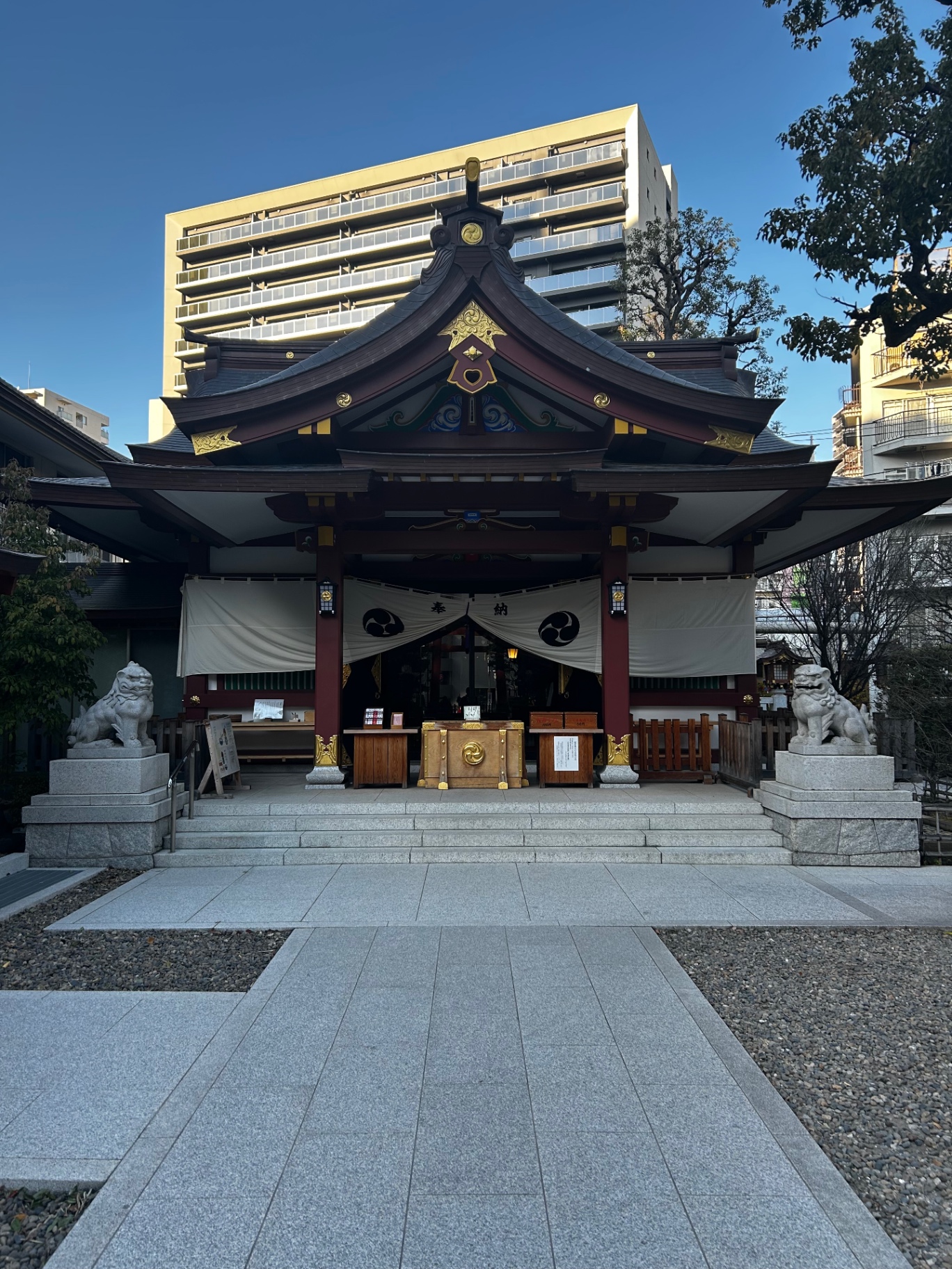 Traditional Shinto shrine framed by city buildings