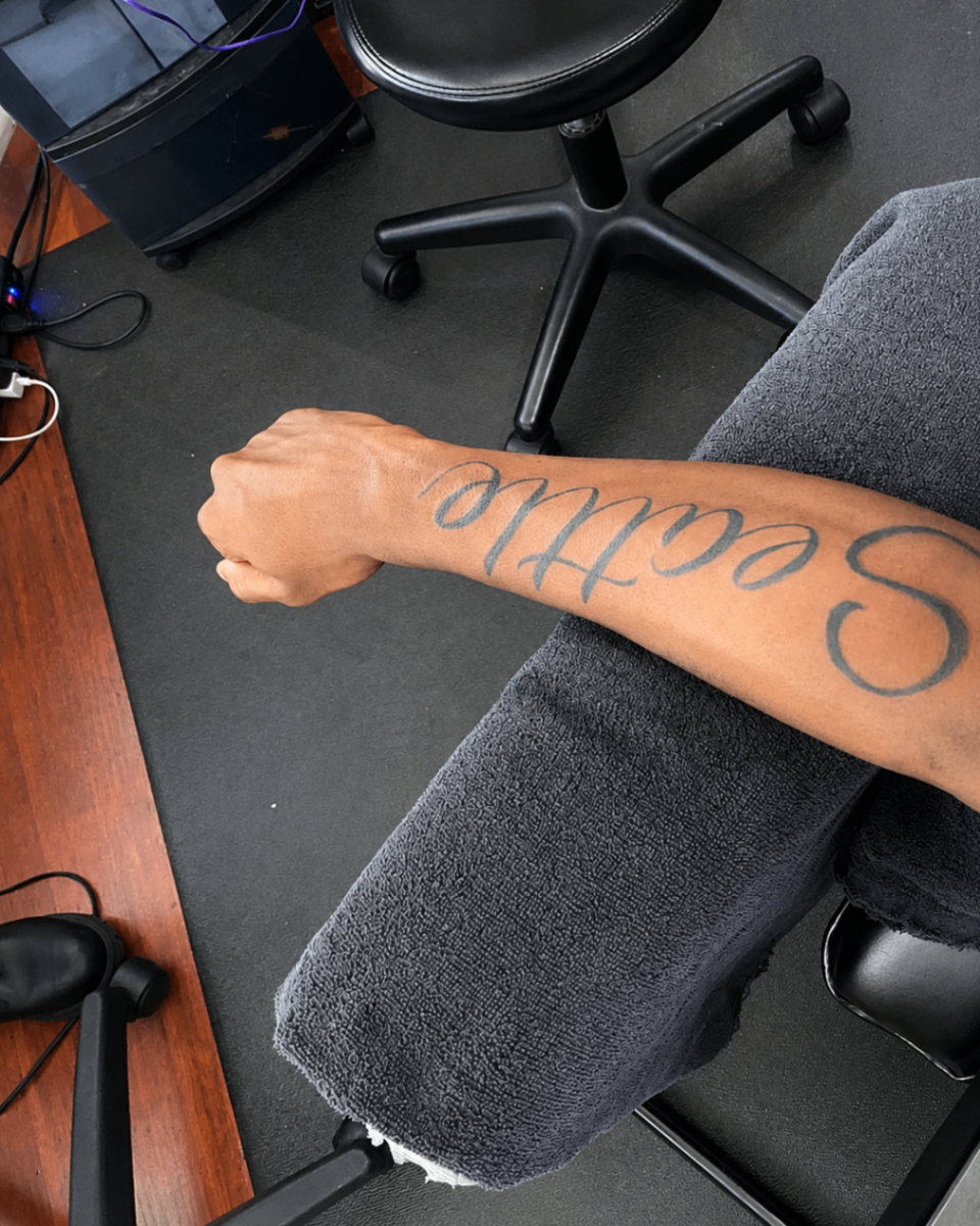Seattle script tattoo on forearm